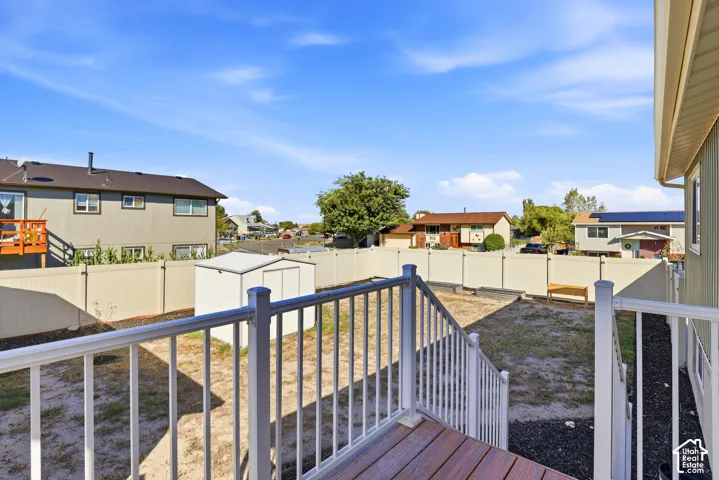 Expansive backyard with a dedicated storage shed, enclosed by a perimeter fence