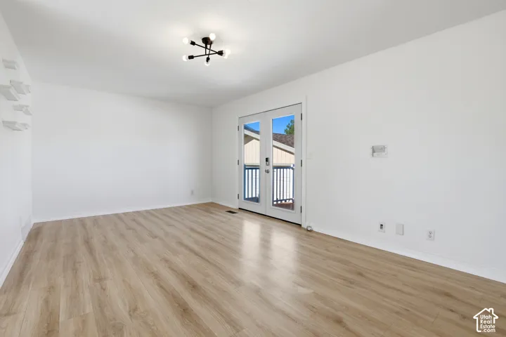 Wood-finish flooring with a modern multi-bulb ceiling fixture
