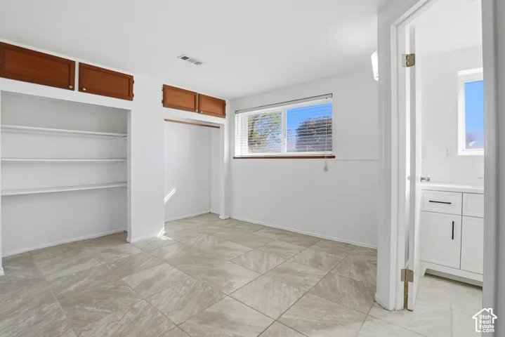 Built-in storage solutions with shelving and upper cabinetry
