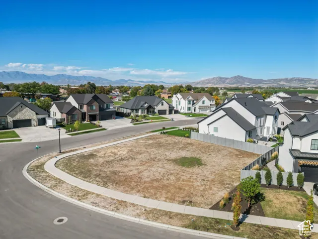 Expansive corner lot featuring a paved street and sidewalk