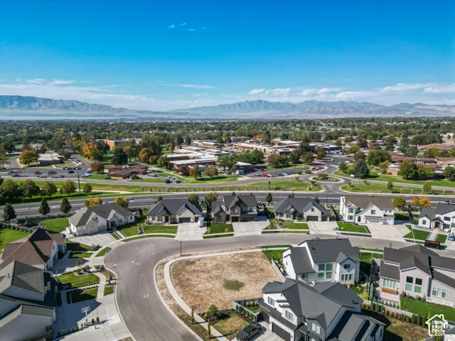 Aerial perspective showcasing a residential development with mountain scenery in the background
