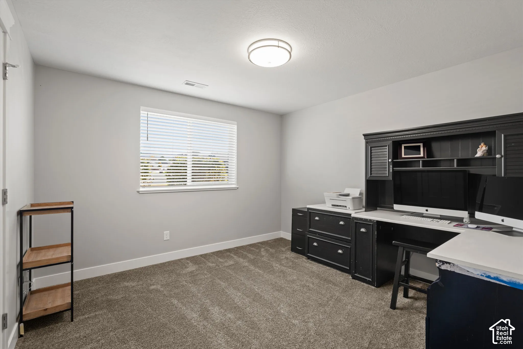Carpeted flooring, neutral wall tones, window with blinds, and flush mount ceiling light
