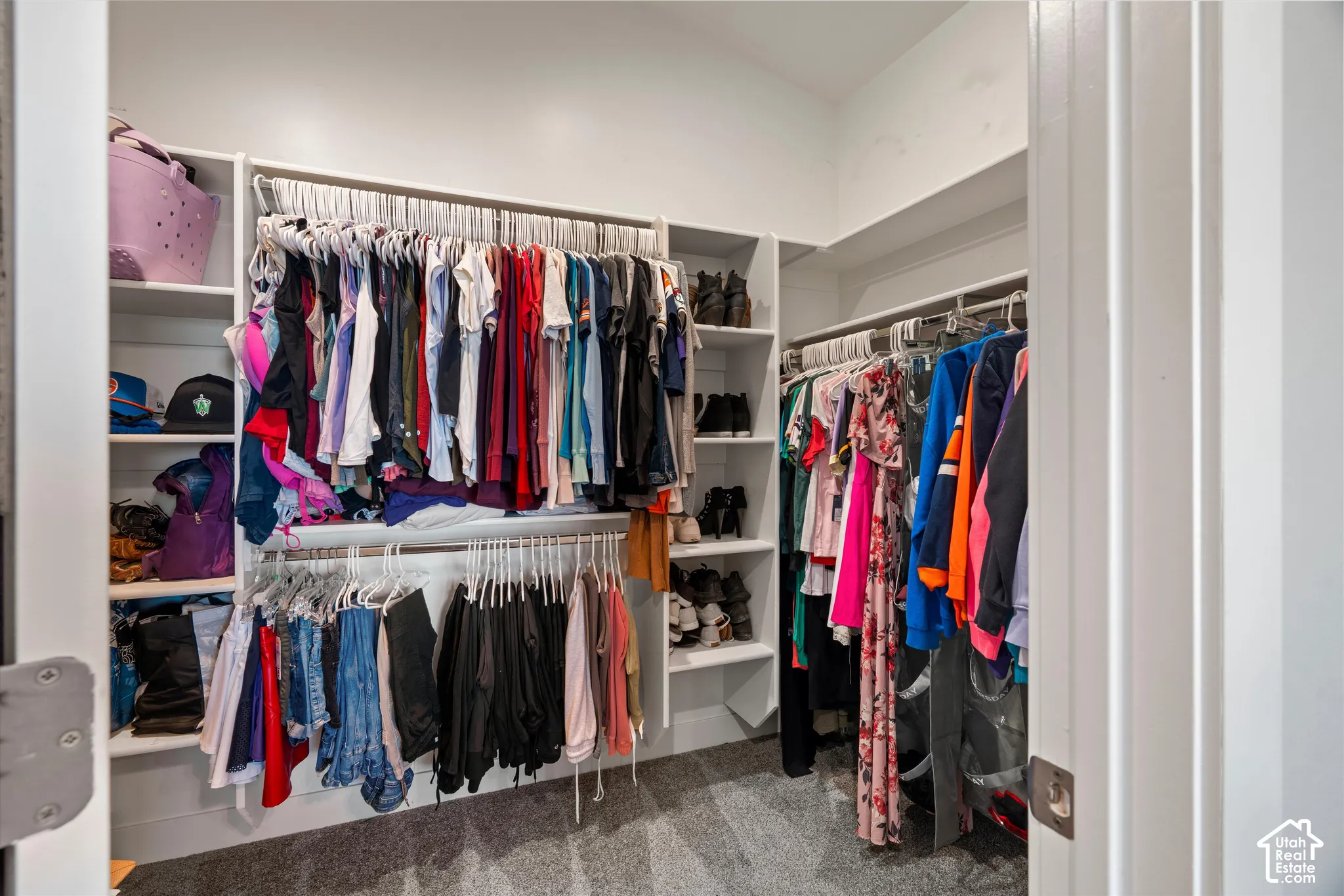 Primary walkin closet with Built-in closet shelving and hanging rods