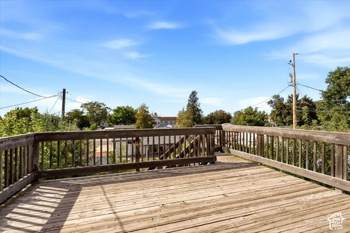 Expansive wood-finish deck with perimeter railing
