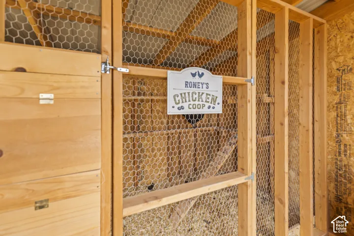 Wood-frame chicken coop featuring wire mesh and a metal latch