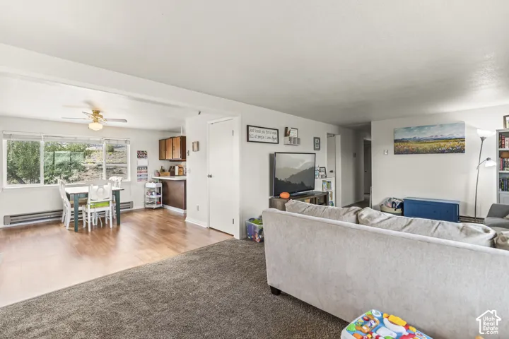 Wood-finish flooring in the dining area with a ceiling fan