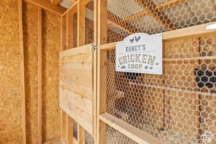 Chicken coop featuring wood-frame construction and wire mesh enclosures