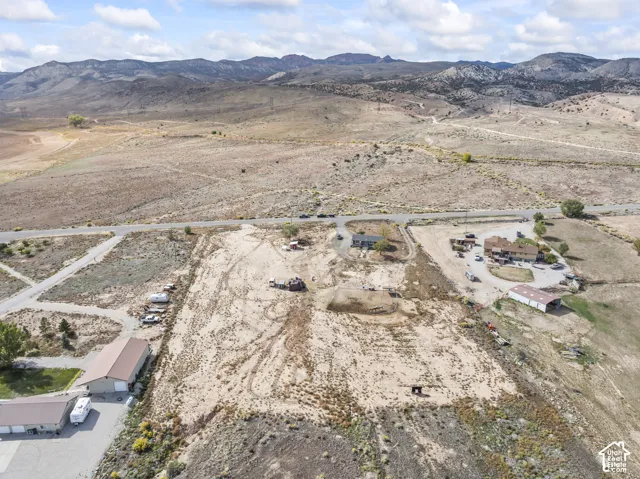 Expansive land parcel with surrounding mountainous terrain