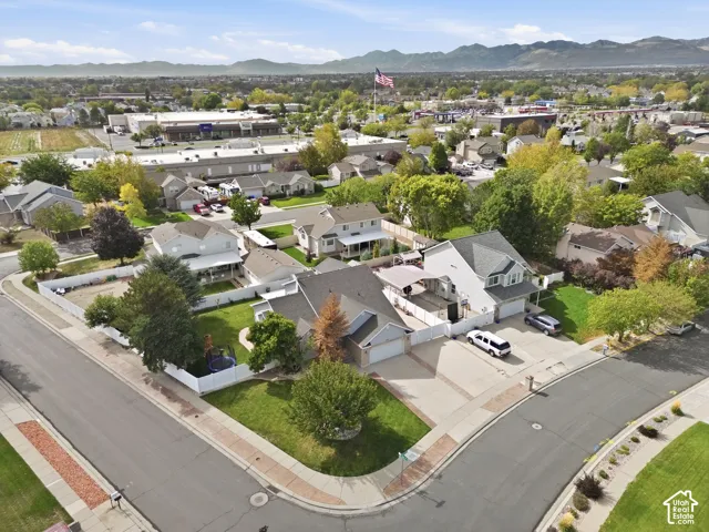 Expansive property featuring a corner lot, mature trees, manicured lawns, paved driveways, and a multi-level structure