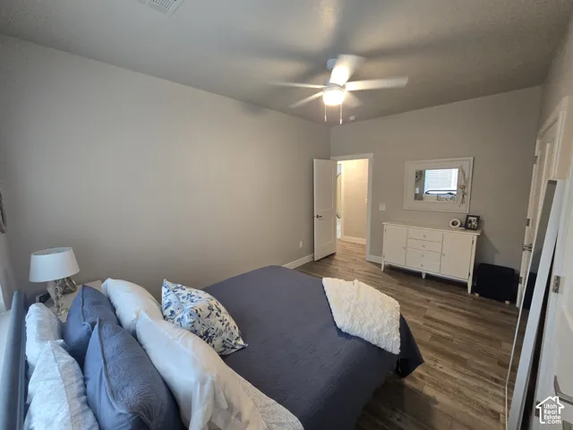 Recessed lighting, wood-finish flooring, ceiling fan with integrated lighting, white trim, and a white interior door
