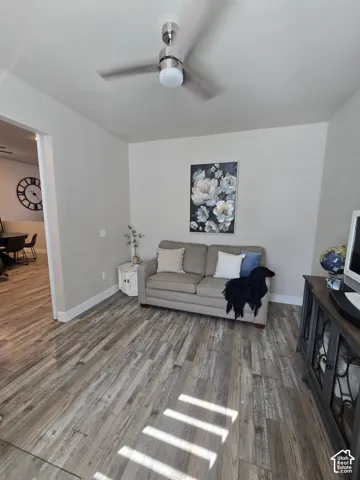 Wood-finish flooring, recessed lighting, and a ceiling fan with integrated light fixture