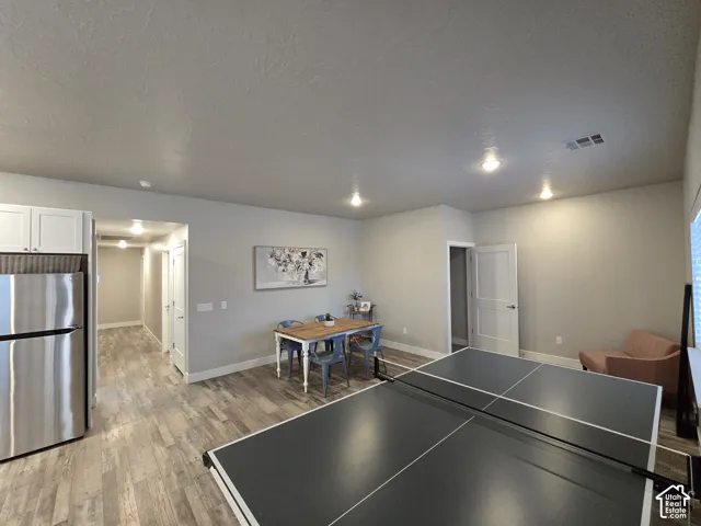 Wood-finish flooring throughout, complemented by recessed ceiling lighting