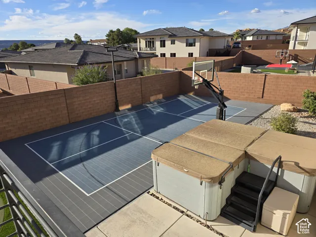 Outdoor sport court with integrated basketball hoop
