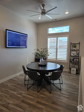 Wood-finish flooring, high ceilings, recessed lighting, and a window with plantation shutters