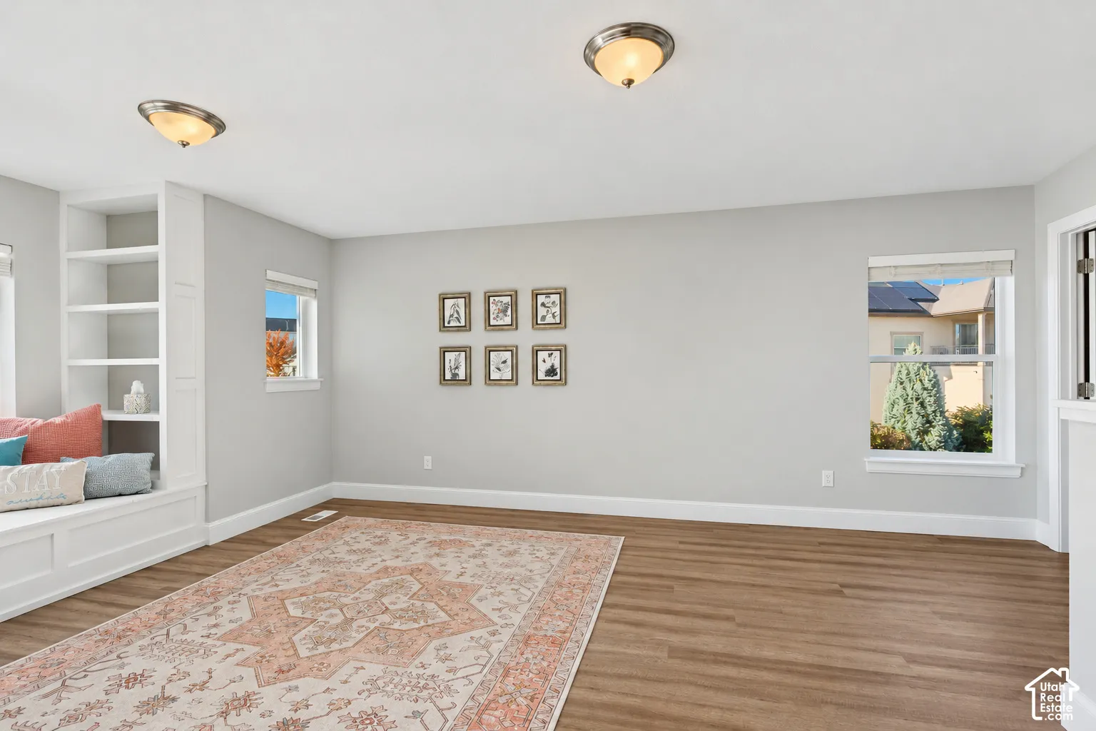 Loft area featuring LVP flooring, incredible natural light, a custom built-in window seat and mountain views