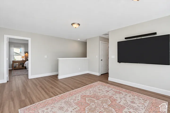 Loft area featuring LVP flooring, incredible natural light, a custom built-in window seat and mountain views