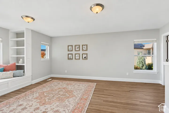 Loft area featuring LVP flooring, incredible natural light, a custom built-in window seat and mountain views