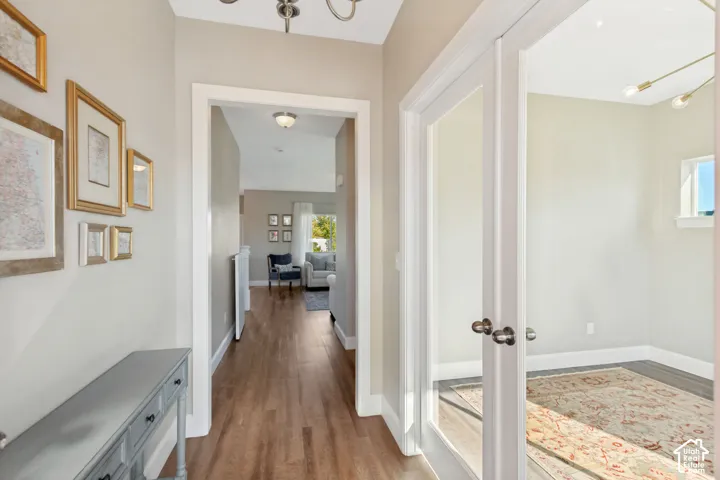 Entryway featuring LVP flooring, white door casings, and glass-paneled double doors
