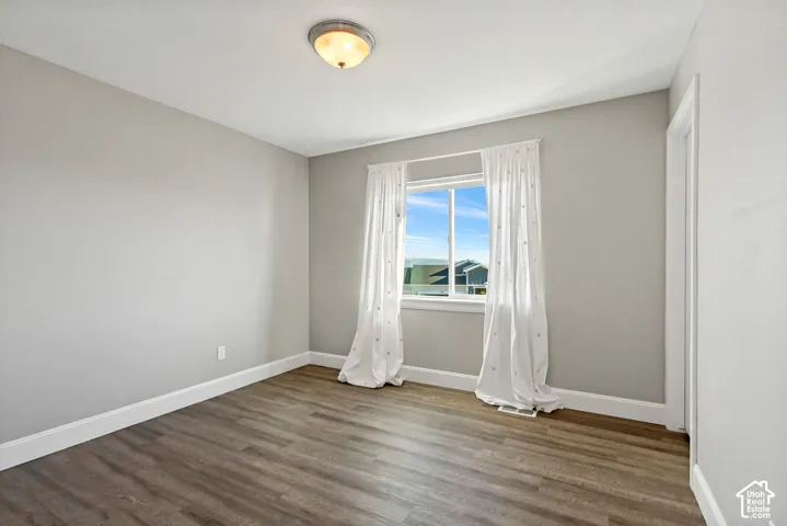 Second bedroom with LVP floorinbg and a large window providing great natural light