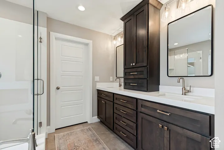 Updated primary bathroom  with dual vanity, storage tower, white quartz countertops and surround and brushed nickel fixtures