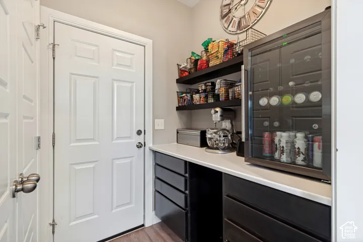 Built-in shelving opposite the pantry, with accommodations for a robot vacuum