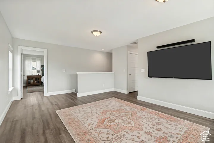 Open and inviting loft area featuring a custom built recessed window seating with built-in storage and excellent natural light