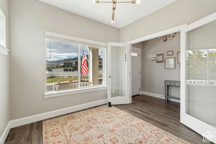 Inviting office with great natural light, large window and double glass-paneled doors
