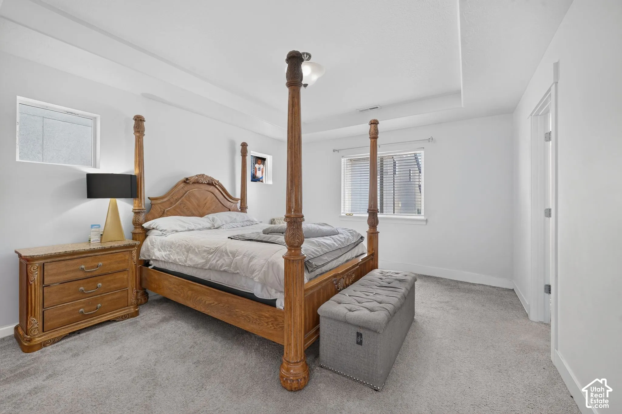 Recessed ceiling detail, light neutral wall paint, and gray carpeting