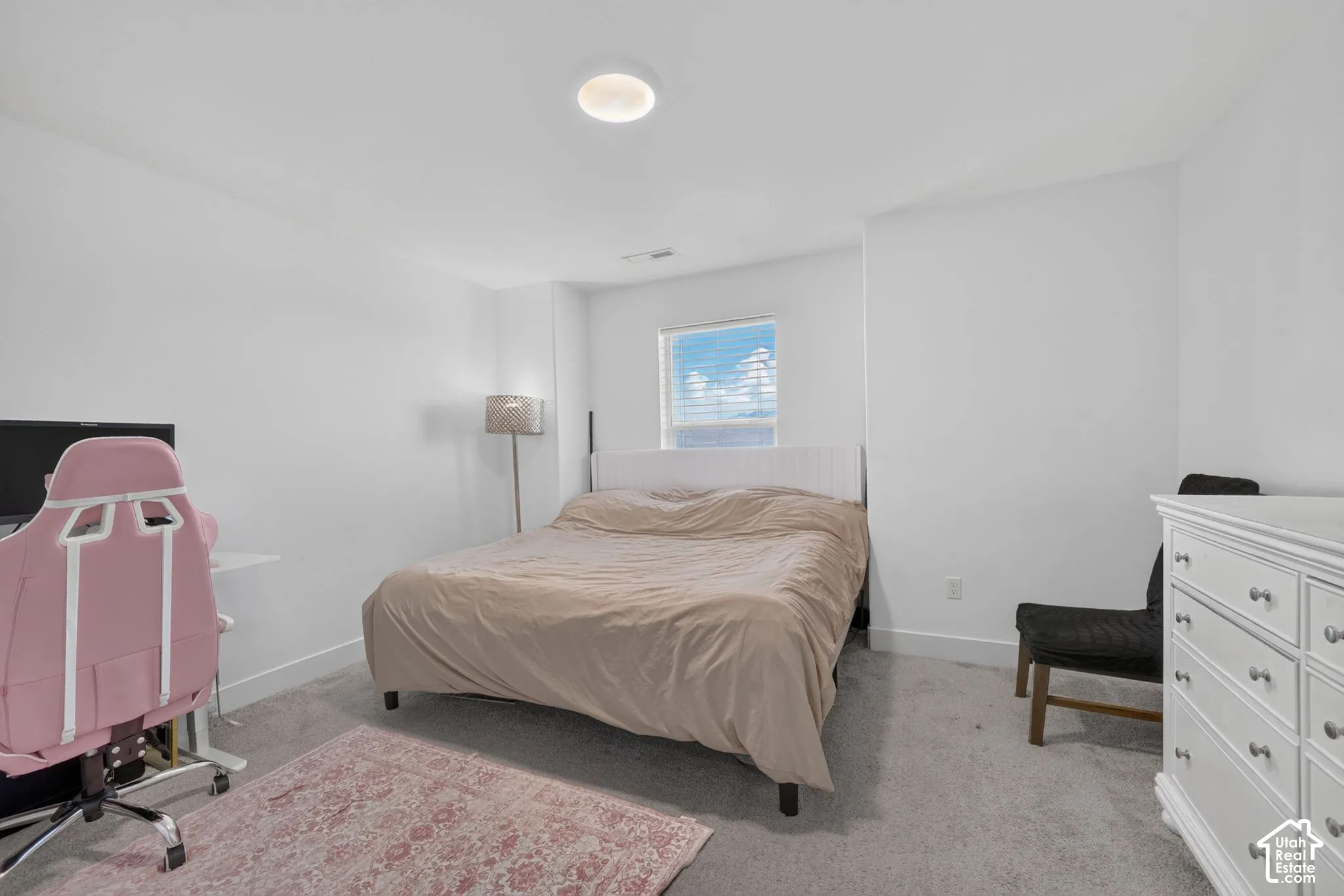 Recessed ceiling lighting, a window with blinds, and light-toned wall paint