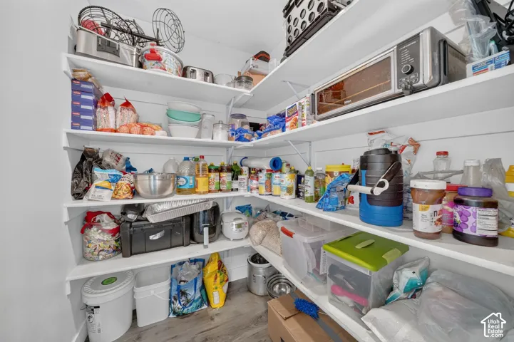 Wall-mounted shelving system featuring white shelves and white brackets, providing ample storage