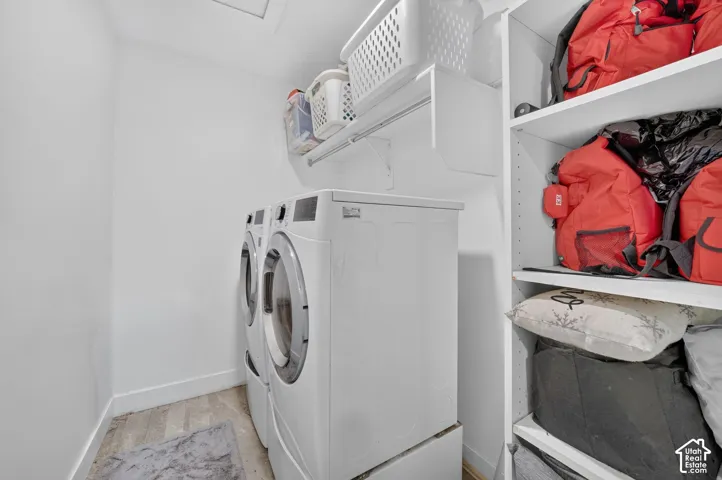 Built-in shelving, white walls, and wood-finish flooring