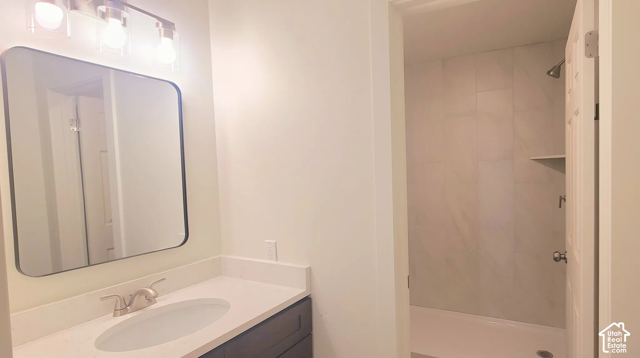 New Vanity, Lighting, and Oversized Step in Shower.