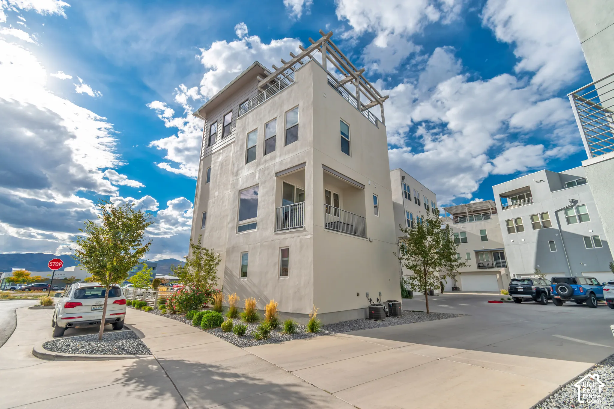 Modern multi-story exterior with stucco finish and multiple windows