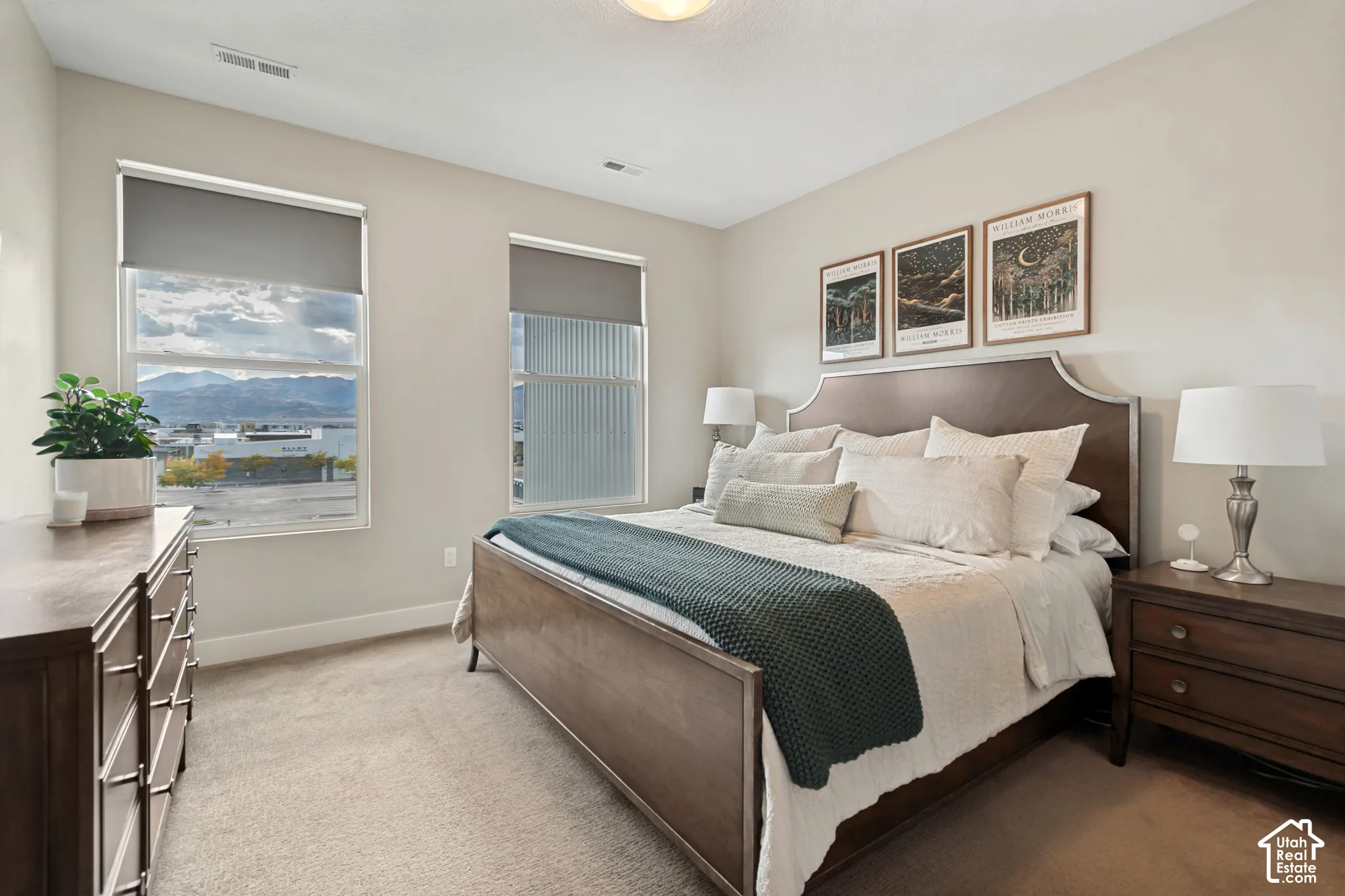 Soft neutral wall tones, recessed ceiling lighting, and carpet flooring