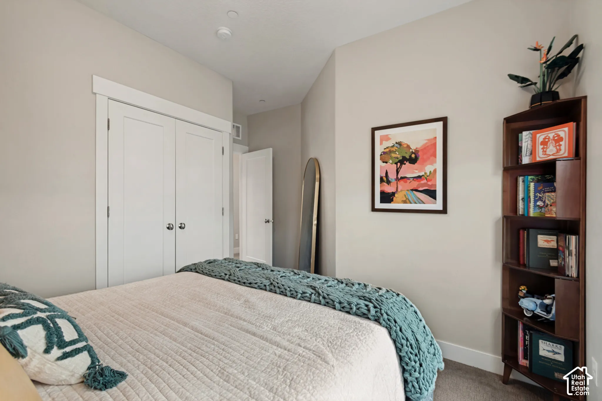 Neutral painted walls, white trim, and carpeted flooring