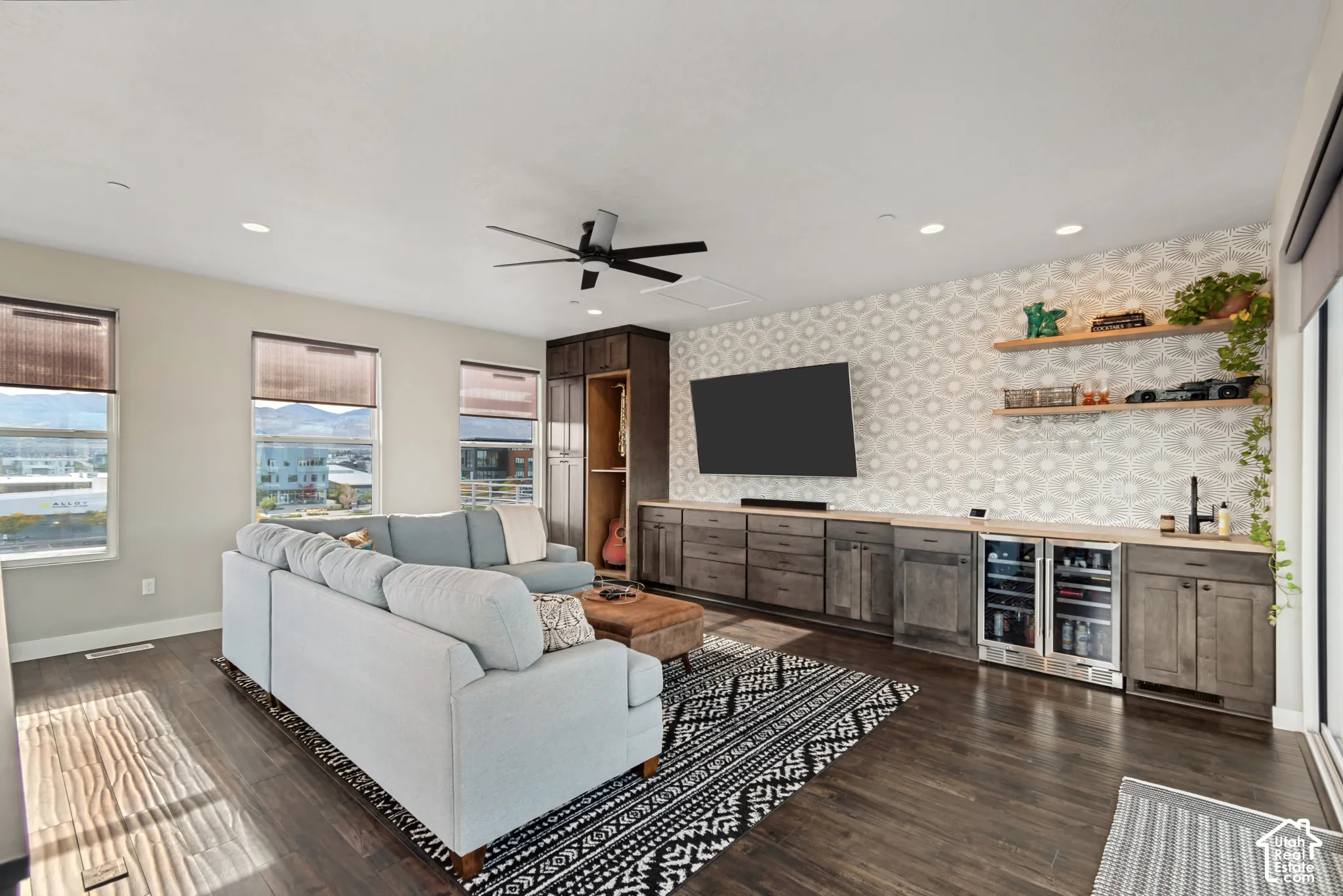 Spacious living area featuring wood-finish flooring, recessed lighting, and a ceiling fan