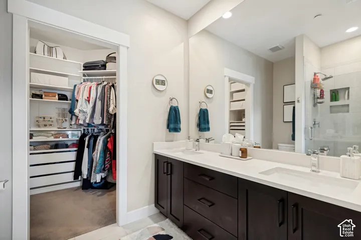 Dual vanity with white undermount sinks and dark wood-finish cabinetry