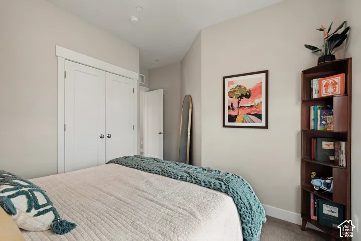 Neutral painted walls, white trim, and carpeted flooring