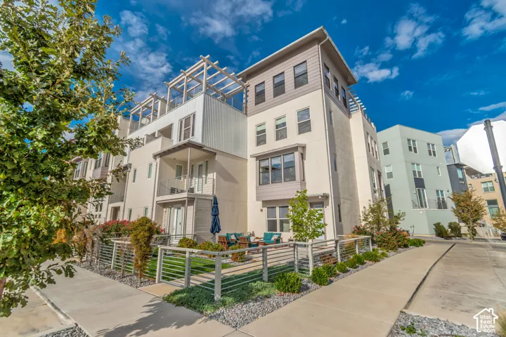 Contemporary multi-level exterior with a private balcony, rooftop pergola