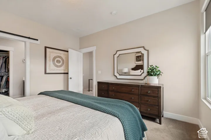 Recessed lighting, light-toned walls, and a window with natural light