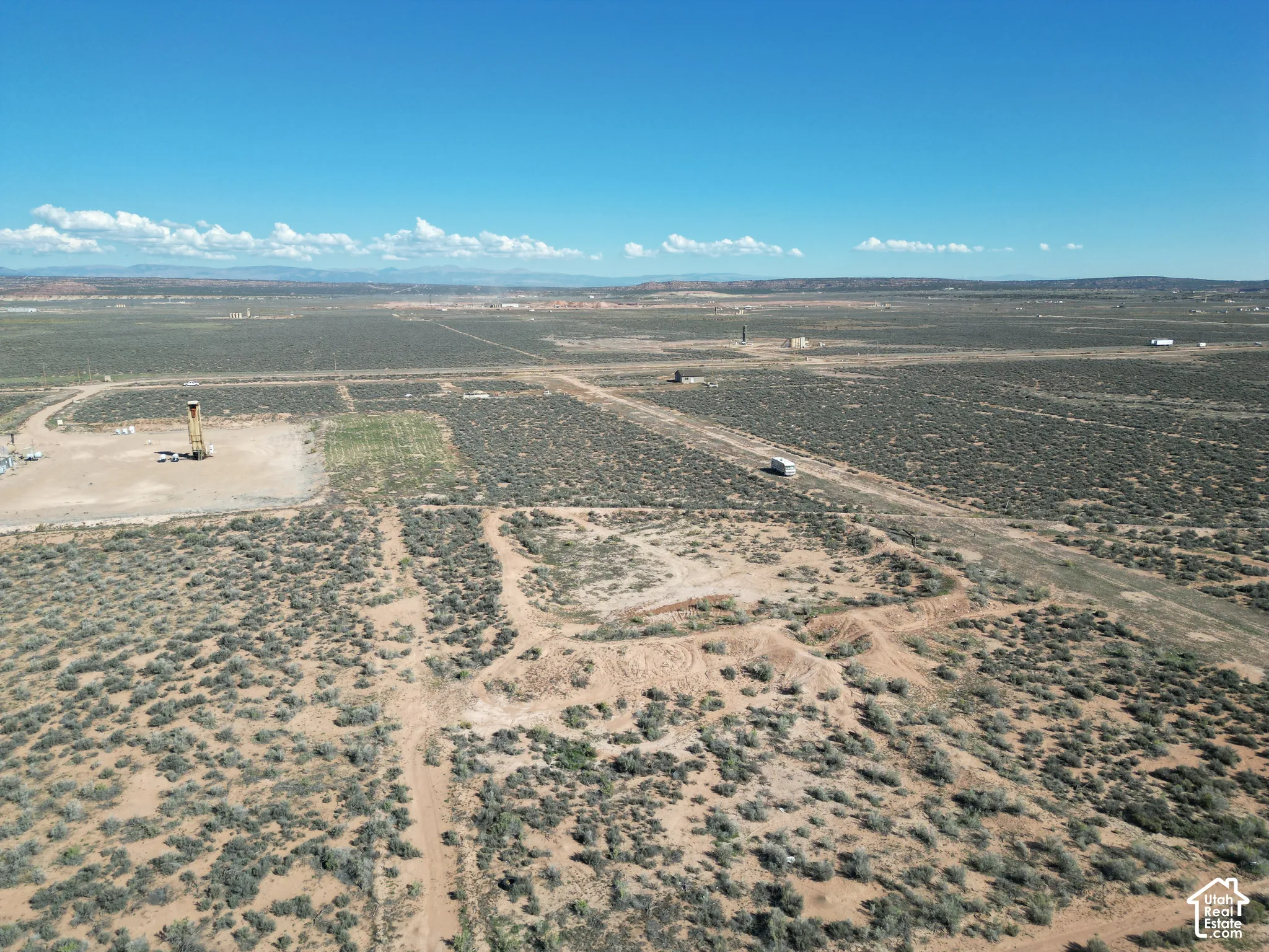 Expansive acreage featuring native desert vegetation, unpaved access paths, and panoramic mountain scenery