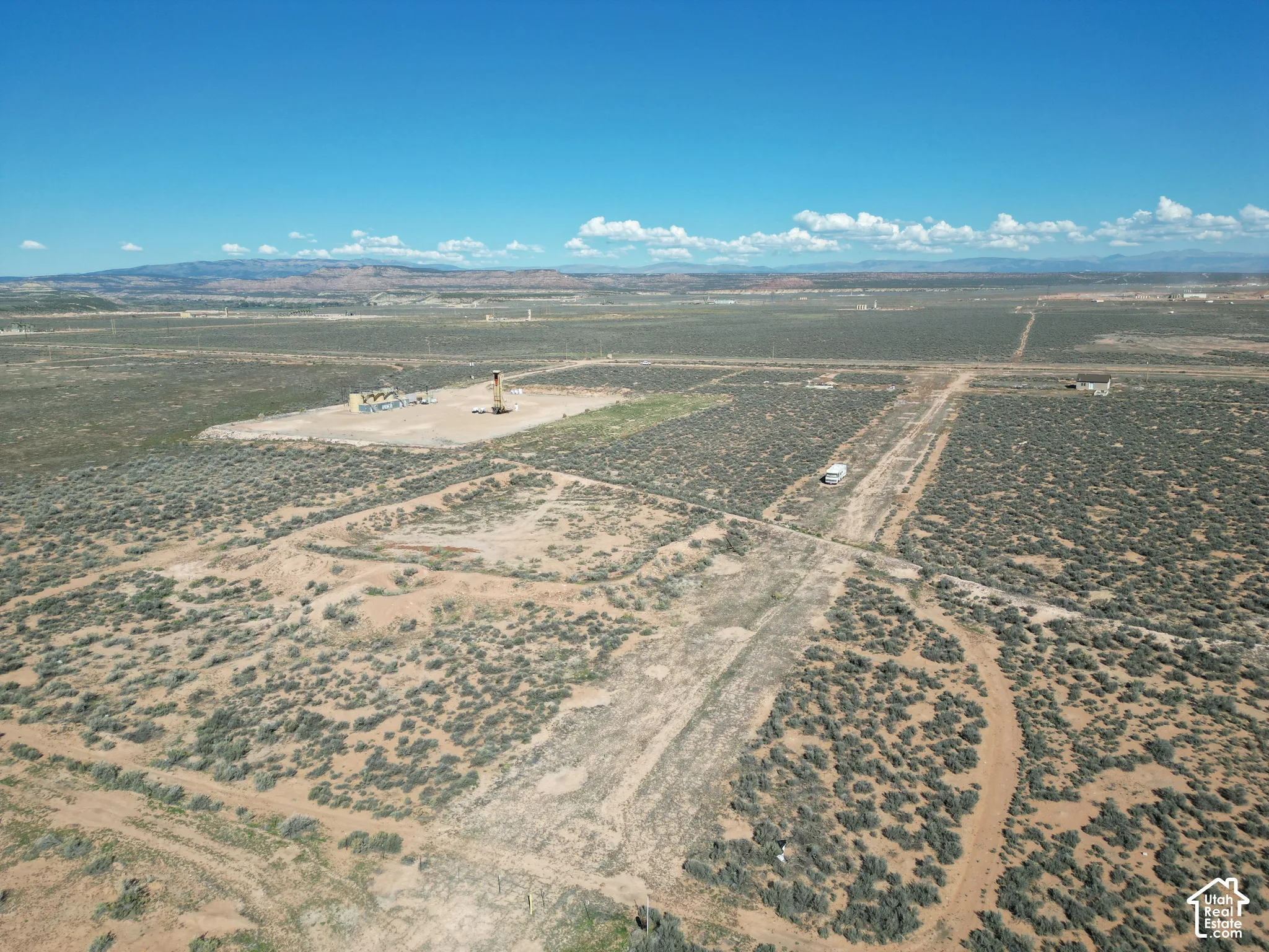 Expansive acreage featuring native desert vegetation, unpaved terrain, and distant mountain topography