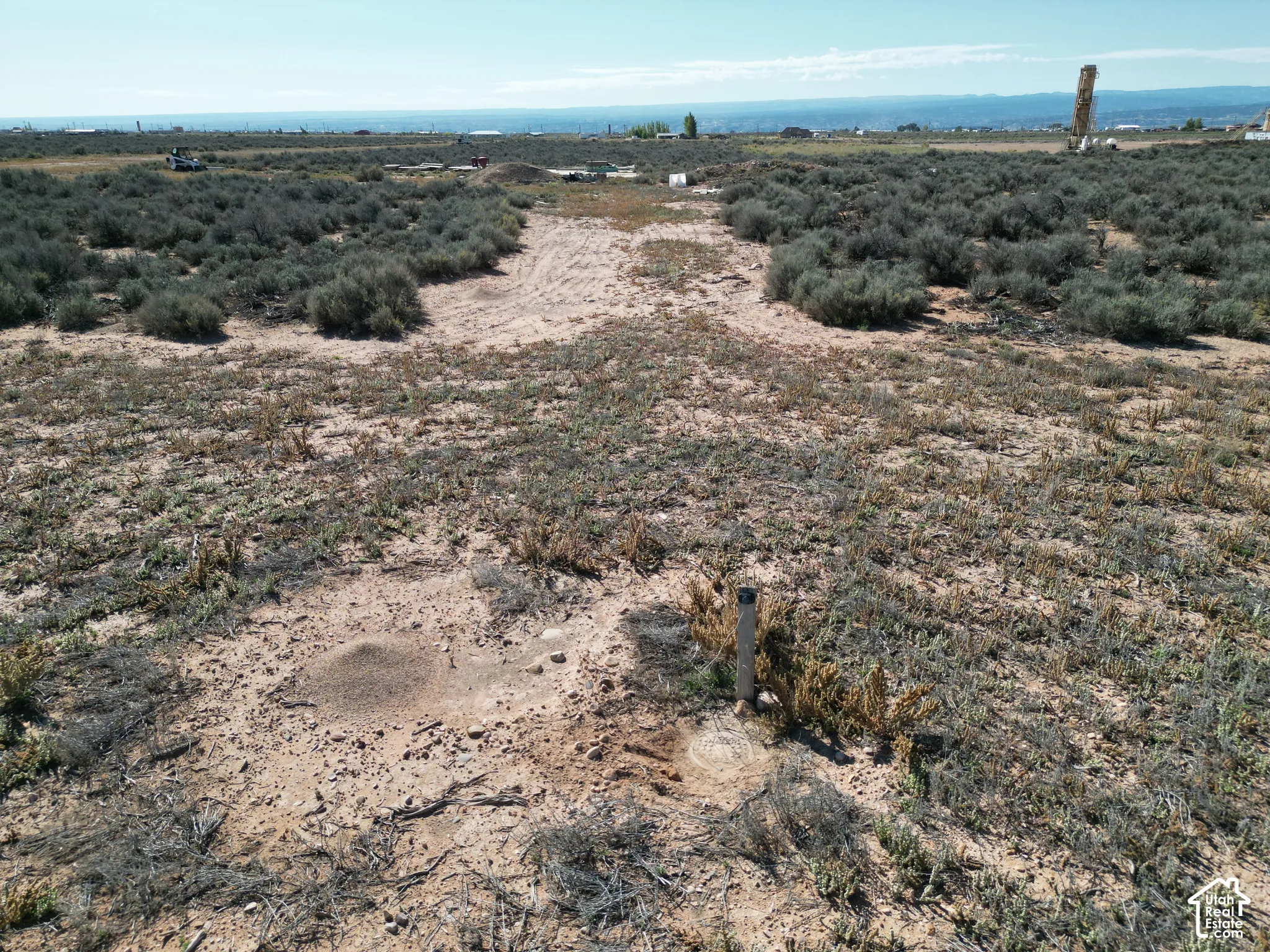 Expansive parcel of open land featuring native desert vegetation and distant mountain silhouettes