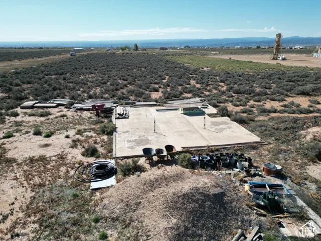 Expansive desert acreage featuring a concrete slab foundation and a prominent mountain backdrop
