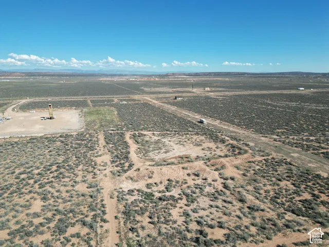 Expansive acreage featuring native desert vegetation, unpaved access paths, and panoramic mountain scenery