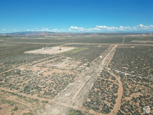 Expansive acreage featuring native desert vegetation, unpaved terrain, and distant mountain topography