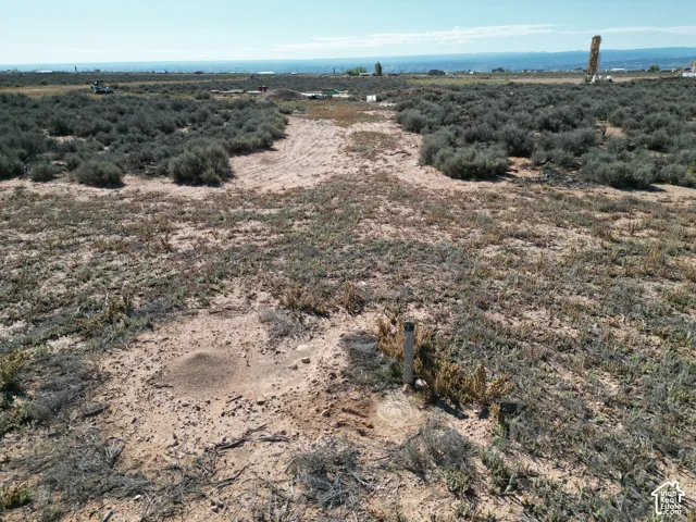 Expansive parcel of open land featuring native desert vegetation and distant mountain silhouettes