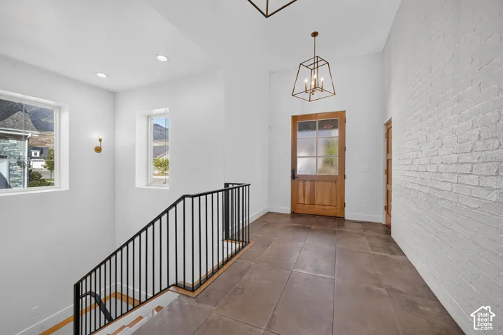 Entryway featuring a textured brick accent wall