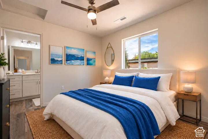 Primary Bedroom featuring wood-finish flooring, a ceiling fan with integrated lighting, and a window with natural light