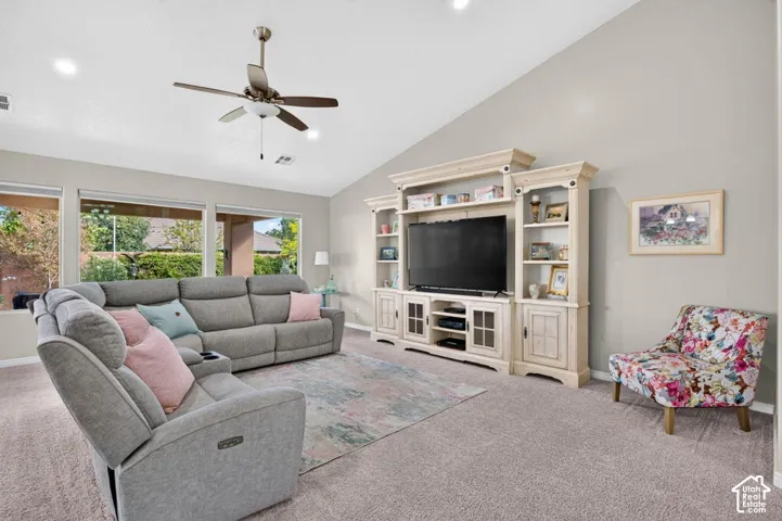 Vaulted ceilings featuring recessed lighting, a ceiling fan, and built-in cabinetry
